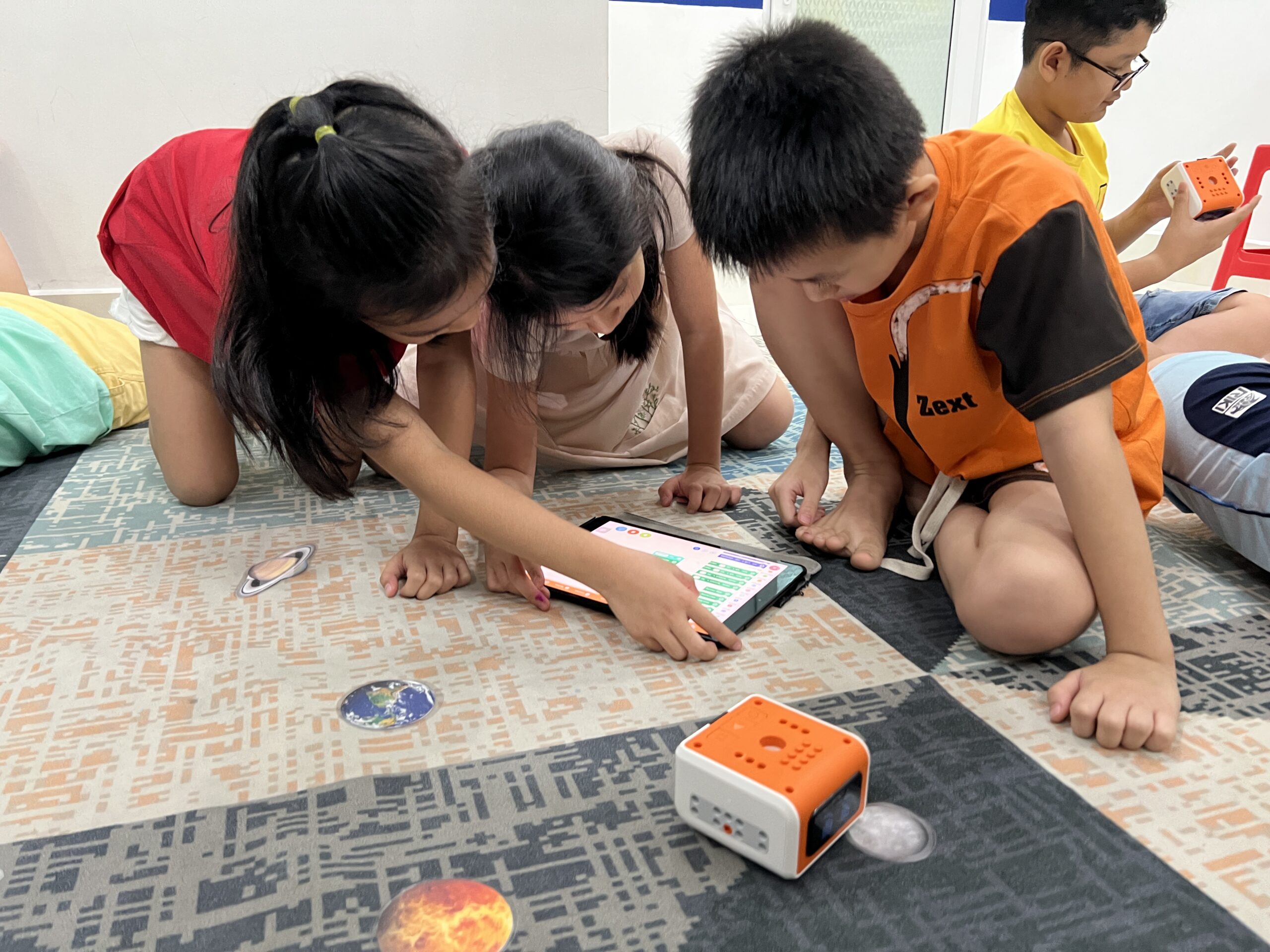 Children collaborating with educational technology